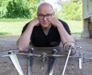 Guy Windsor with a selection of steel swords and daggers. Not plastic swords.